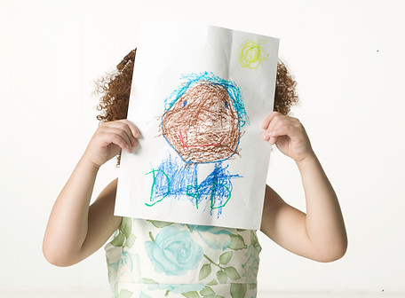 Child Holding Artwork