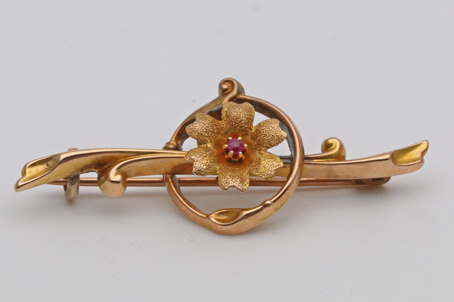 Art nouveau gold and ruby bar brooch