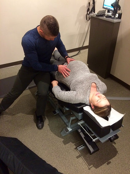 Chiropractic adjustment being given to a pregnant woman.