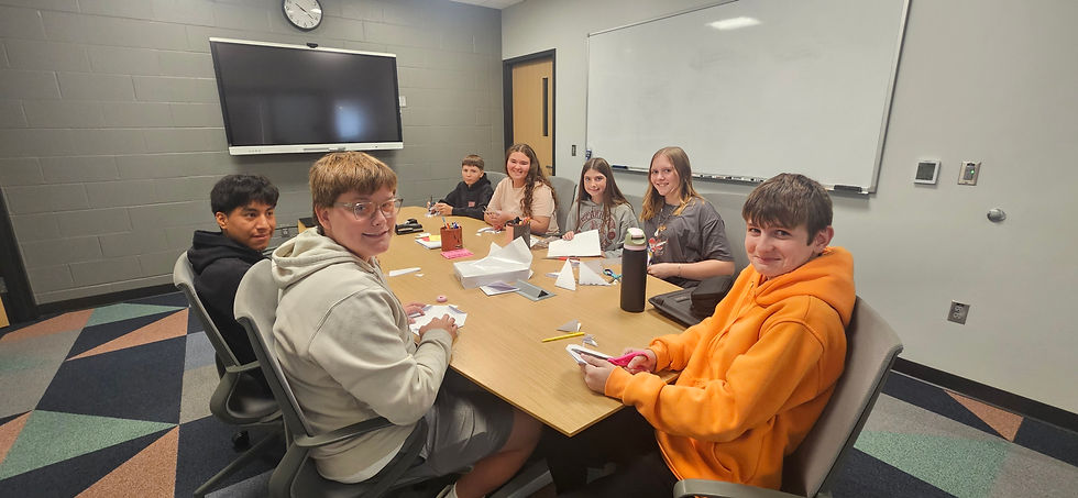 Monticello Middle School students creating snowflakes to decorate the entry way into the Renaissance Center at Holiday on 1st in 2025.