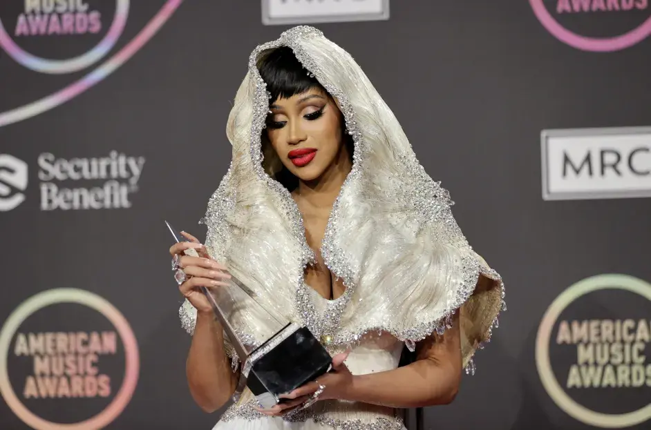 Cardi B fashionably beautiful in a wedding dress type of ensemble accepting an American Music Award.
