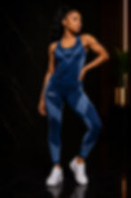 Woman wearing the Biilow Movement Collection Velocity Set in navy blue, featuring a performance tank and high-waisted leggings designed for comfort, flexibility, and an active lifestyle.