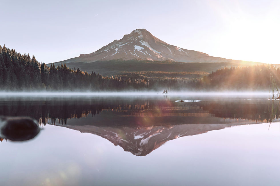 Mt. Hood reflected in misty lake at sunrise