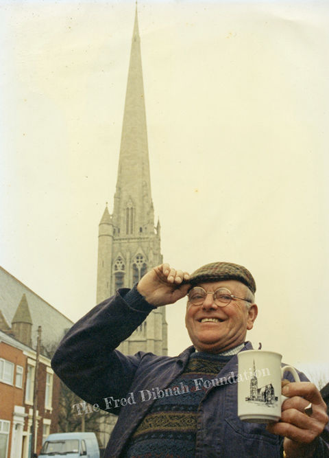 Fred Dibnah in front of a church spire