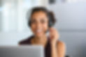 Call center agent with headset working on support hotline in modern office. Young african