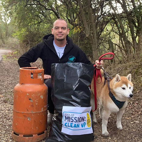 ZooLab ranger Chris and his dog cleaning up some rubbish for World Clean up Day.