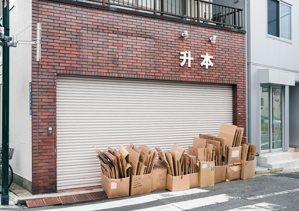 detail of recycling piled outside closed shopfront in Yoyogi Uehara photographed by Keith Ng