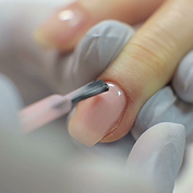 videoblocks-nail-care-and-manicure-closeup-of-beautiful-female-hands-applying-transparent-