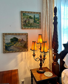 Vintage lamps and original French oil paintings grace the St Avold Suite