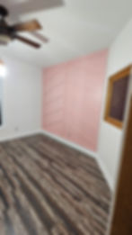 Bedroom renovation with new flooring and pink accent wall