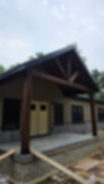 Home under construction and remodeling with wood porch.