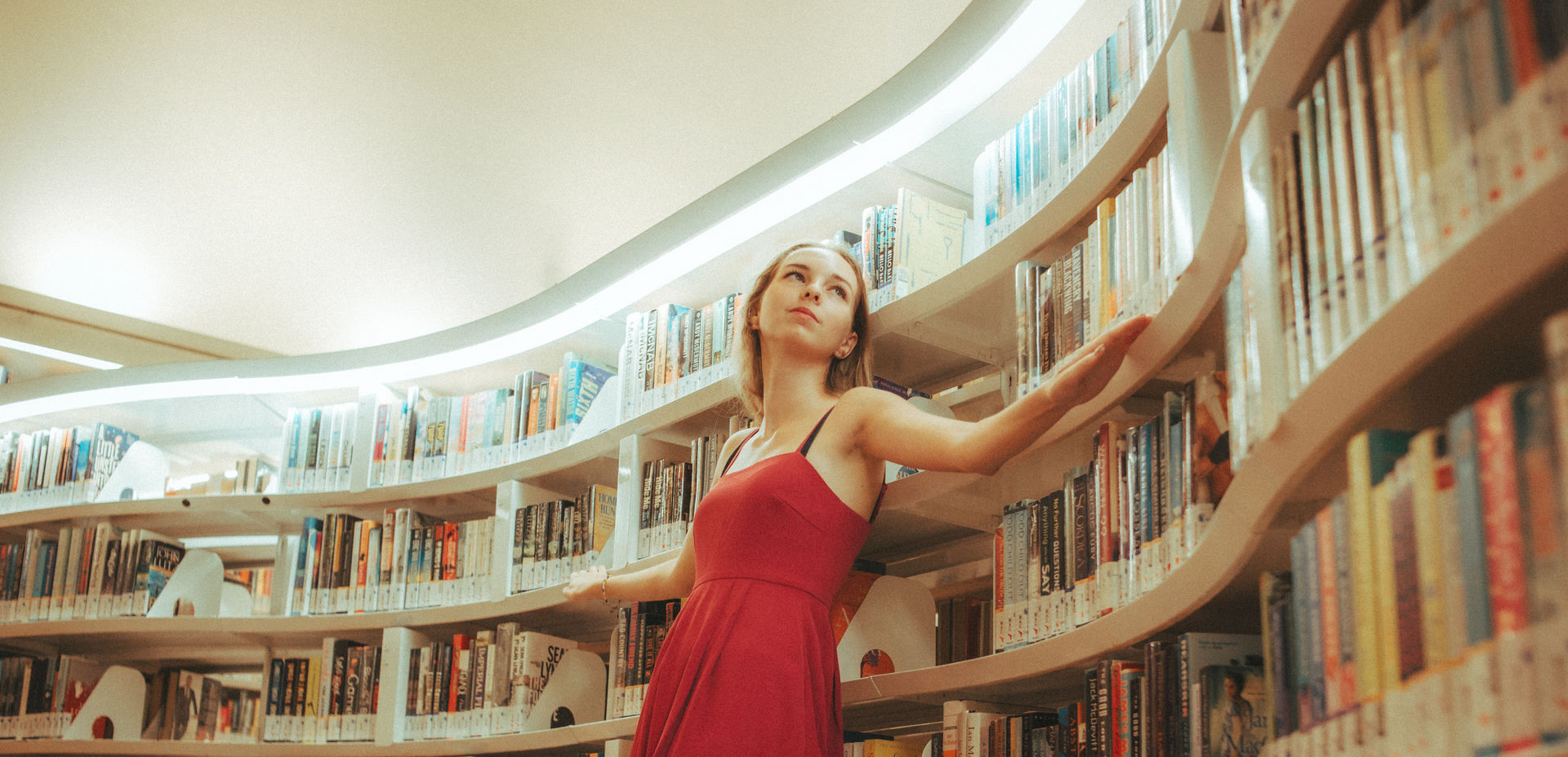 Girl in red photoshoot in public library