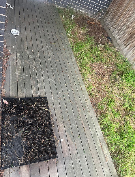 Deck before water pressure cleaning, showing built-up dirt and weathered timber surface awaiting restoration.