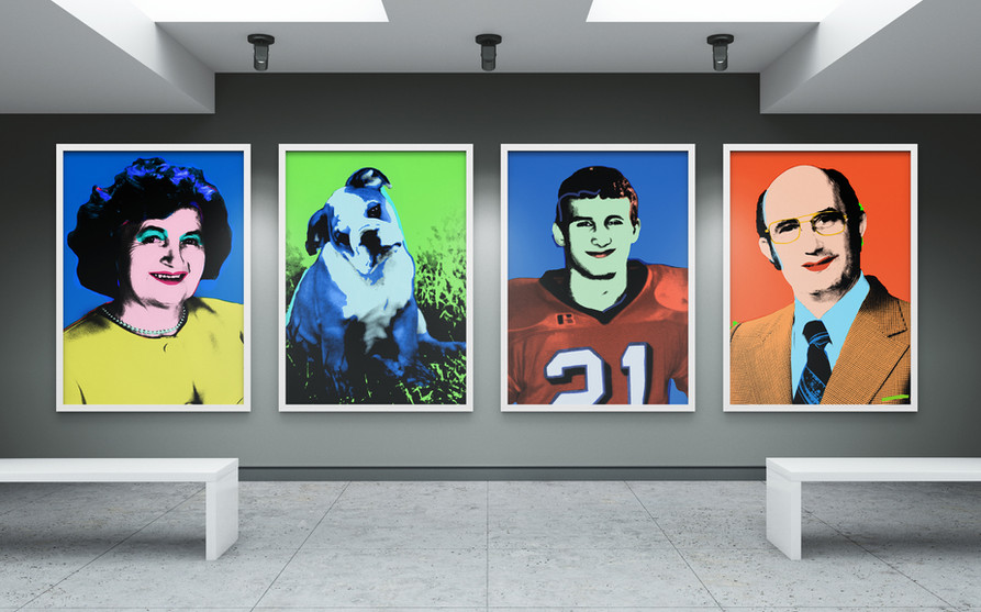 Four pop art style portraits on a wall