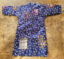 a front view of the mini jacket, showing the variety of patches and stitch patterns