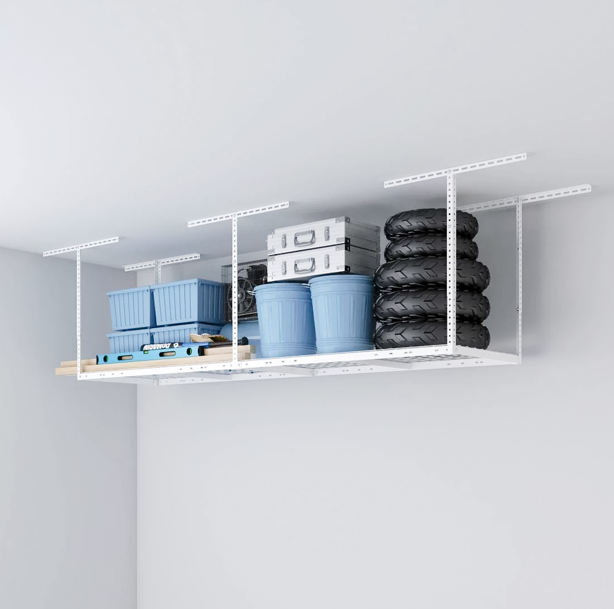 White ceiling-mounted overhead storage rack holding plastic bins, storage boxes and a stack of tires
