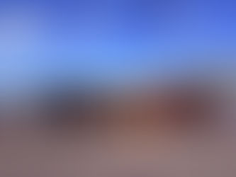 iPRES 2025 attendees in front of the Wellington sign on the waterfront.