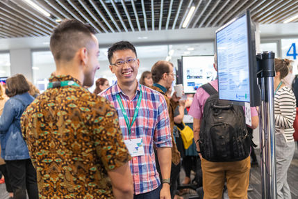 Attendees at a poster session at iPRES 2022 in Glasgow, Scotland. 