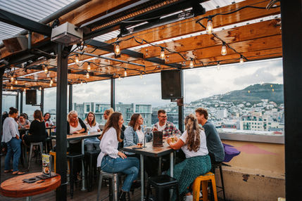 People sitting around a table at a bar.