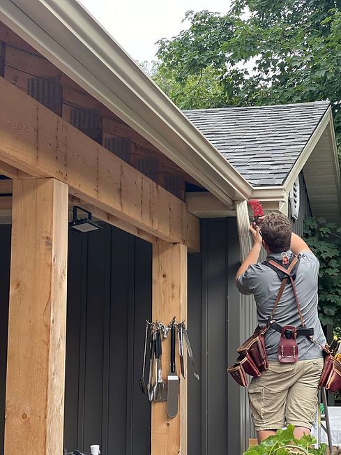 Eavestrough installer riveting a downspout in Meaford, ON