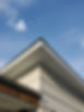 New White soffit and fascia installed on the corner of a house.