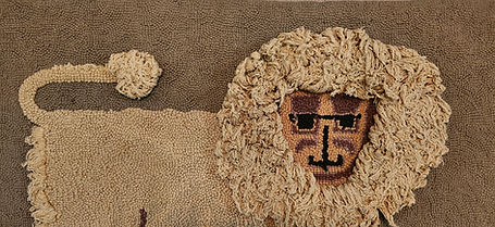 folk art hooked rug of a lion with a shaggy mane and tail