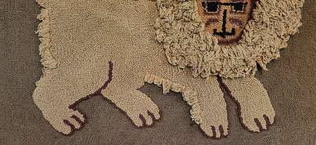 folk art hooked rug of a lion with a shaggy mane and tail