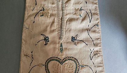 18th century linen sewing pocket embroidered with a heart set among meandering vines and flowers