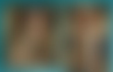 Two elegant women in vintage attire, one with dark hair, the other blonde, stand in a lavish room with chandeliers and floral wallpaper.