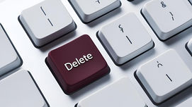 maroon delete key on white keyboard