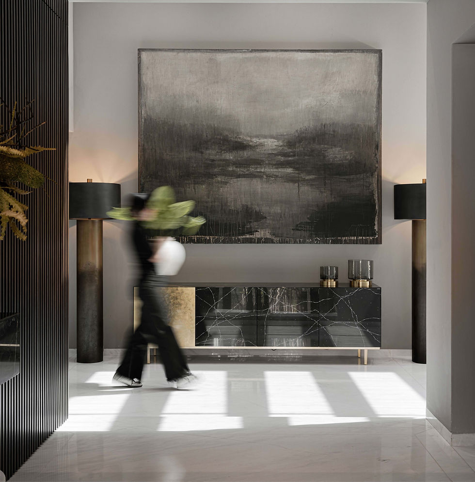 Residential entryway featuring contemporary furnishings, large-scale artwork, and natural light, showcasing elegant and timeless luxury interior design.