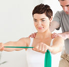 women stretching with green resistance band