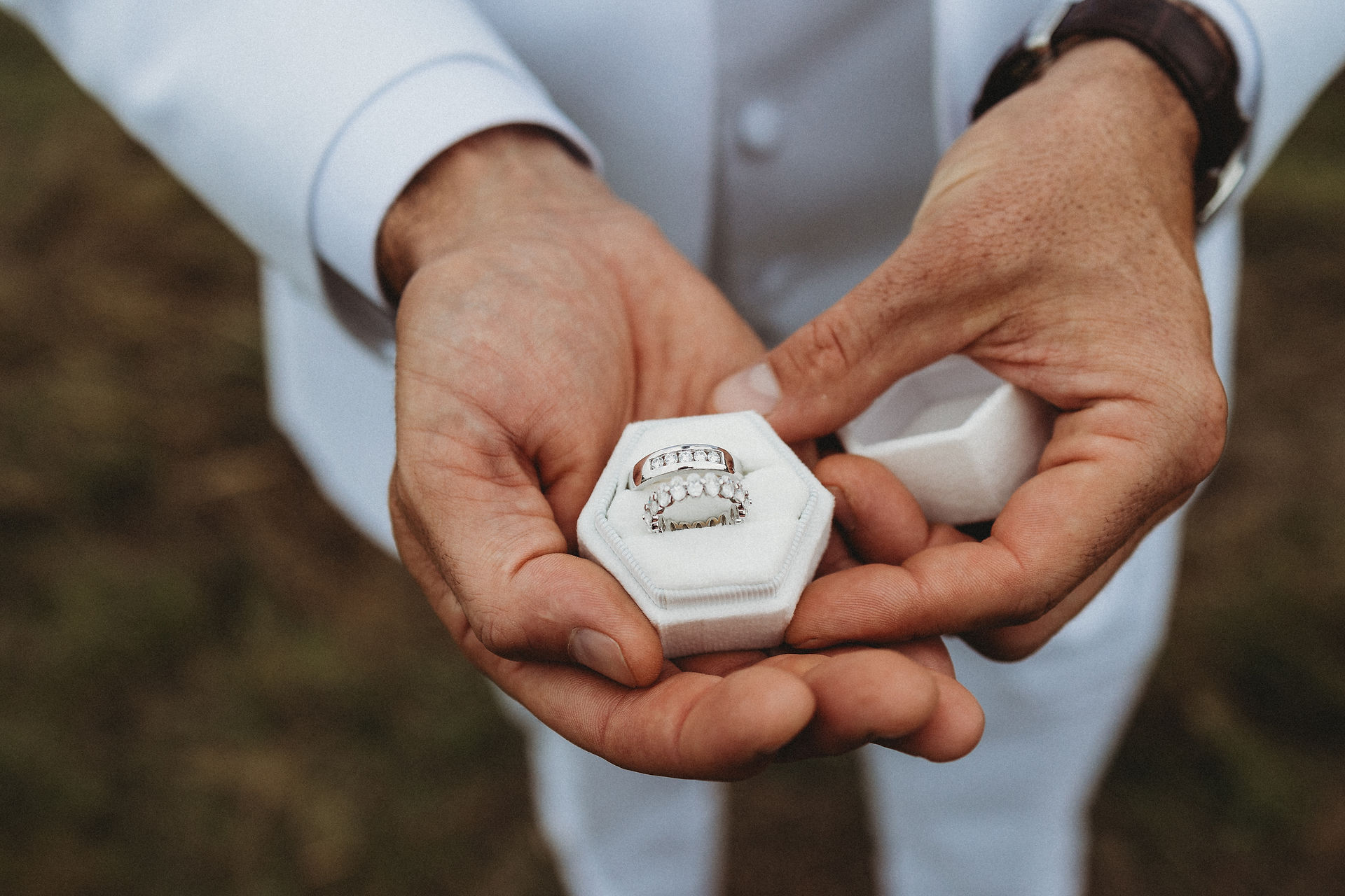 A groom holding wedding rings before the ceremony