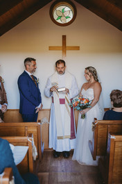 Bride and groom inside the chapel during the ceremony; Niagara Elopement Photographer