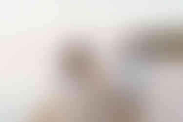 Engagement photo of a couple playfully walking at the beach in Niagara