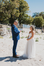 A first look between bride and groom on a beach; niagara elopement photographer