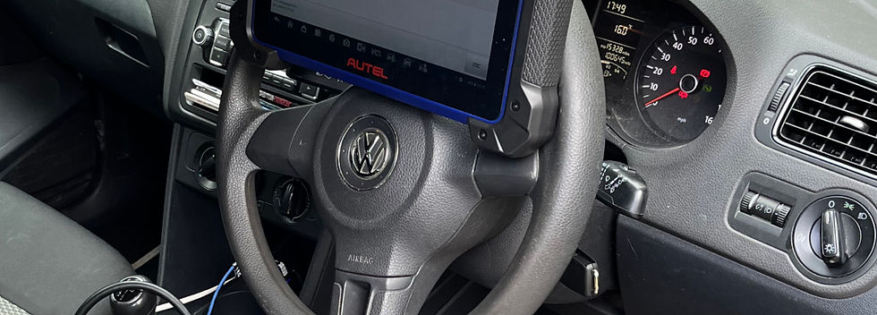 car key programmer on steering wheel of VW vehicle