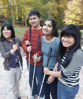 Four visually impaired friends standing and smiling