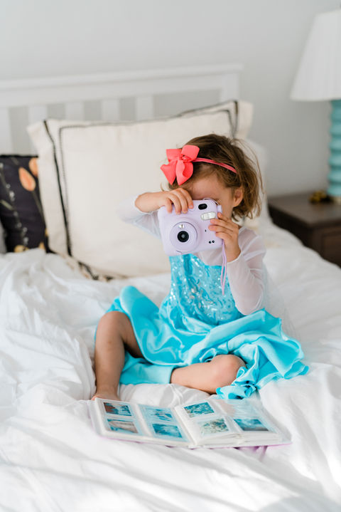 toddler with camera taking picture