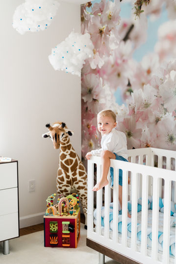 happy boy climbing out of crib