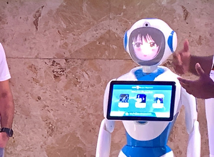 Two tablets and a service robot displaying event application landing page, reading ‘Welcome to Elevate 2019’.