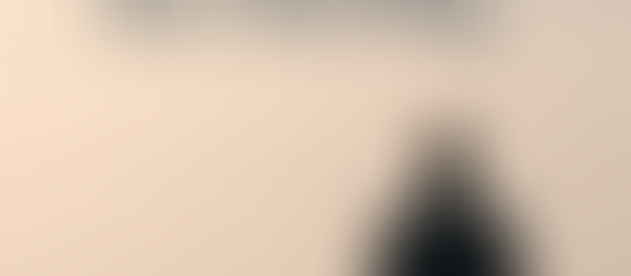 A solitary figure standing at a distance in a quiet landscape, with the words “slow but moving” over a muted background.