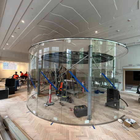 Interior shop fitting, curved glass, frameless floor to ceiling glass.