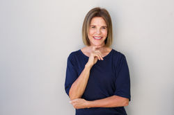 older-woman-smiling-with-hand-to-chin-49