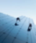 low-angle-shot-two-persons-rappelling-side-tall-building.jpg