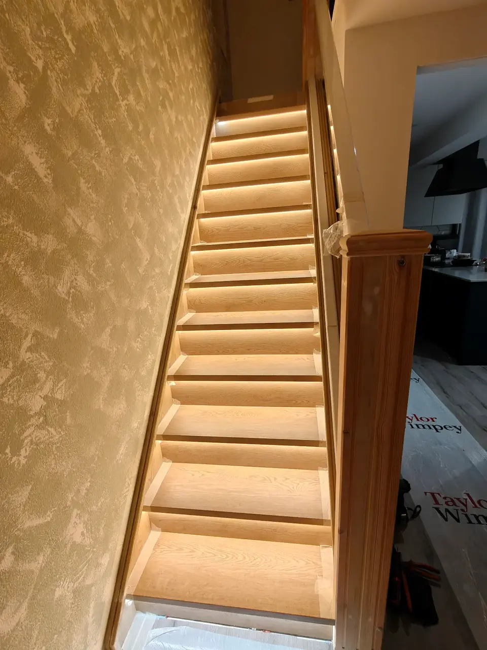 Modern staircase with automated LED smart lighting installed by a qualified electrician.