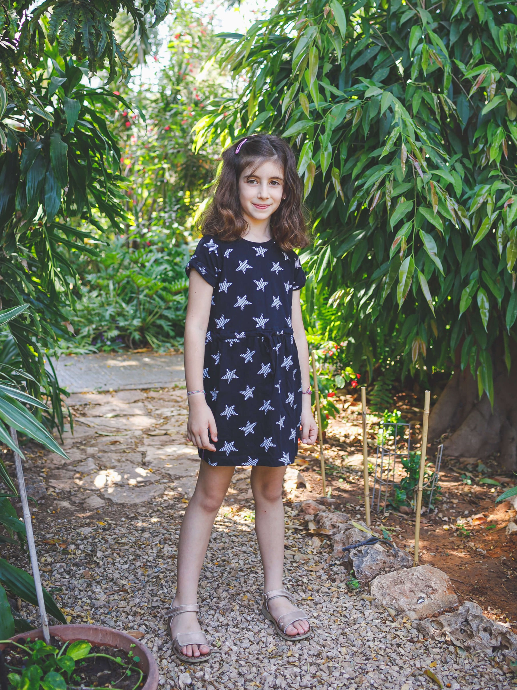 ילדה חמודה בשמלה שחורה עם כוכבים