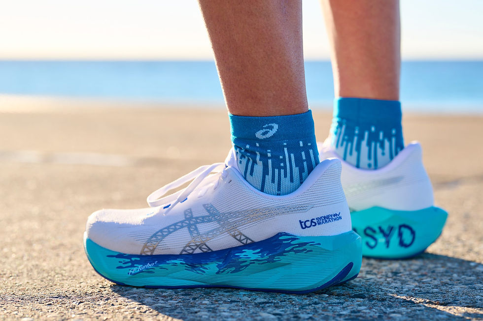 Asics running shoes with blue socks by the coast