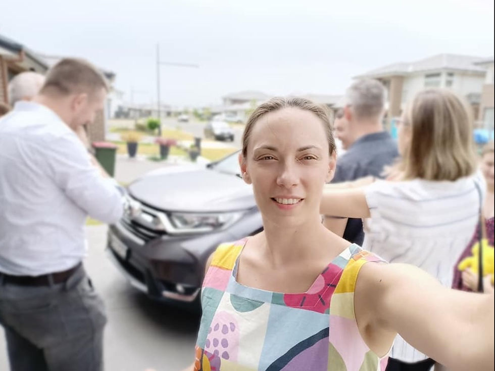 Ana Mitrovic taking a focused selfie while life buzzes in the background — a snapshot of balance and calm in a work from home lifestyle.