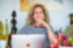 Sarah Hampel working remotely with her laptop during travels — showcasing how to make money while traveling through Prosperity Of Life.